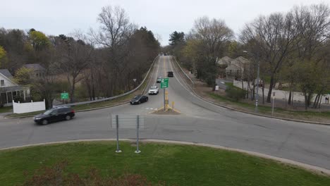 static drone clip of traffic navigating a rotary and some offshoot roadways