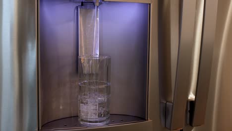 glass filling with water from refrigerator