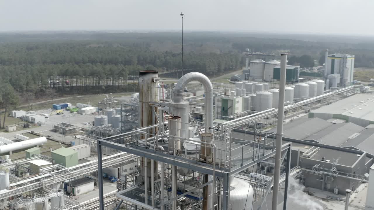Aerial drone view reveals large factory in Veille-Saint-Girons, showcasing industrial manufacturing and production processes, surrounded by forest, France