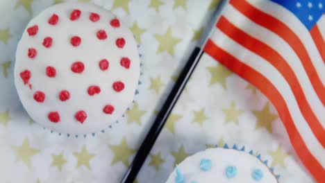 Close-up-of-drink-and-cupcake-with-4th-july-theme