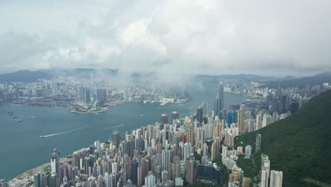 aerial perspective though clouds of victoria habour, hong kong skyscrapers island district