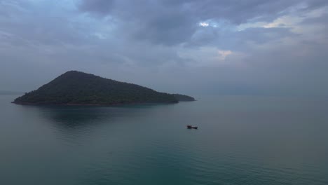 koh rong sanloem island village in cambodia, featuring turquoise water, pier, boats and tropical jungle. dramatic aerial view flight panorama overview drone