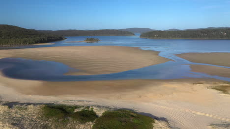 Cinematic-revealing-drone-shot-of-Sandbar-Beach-and-Smith-Lake-in-New-South-Wales-Australia