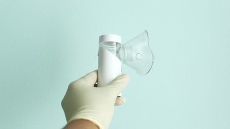 handheld nebulizer in hand