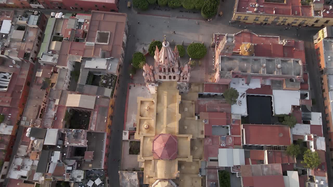 Aerial tilts directly down on Parish of Saint Michael in San Miguel MX