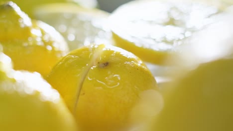 slow motion of water splashing from sliced fresh lemon, close-up shot