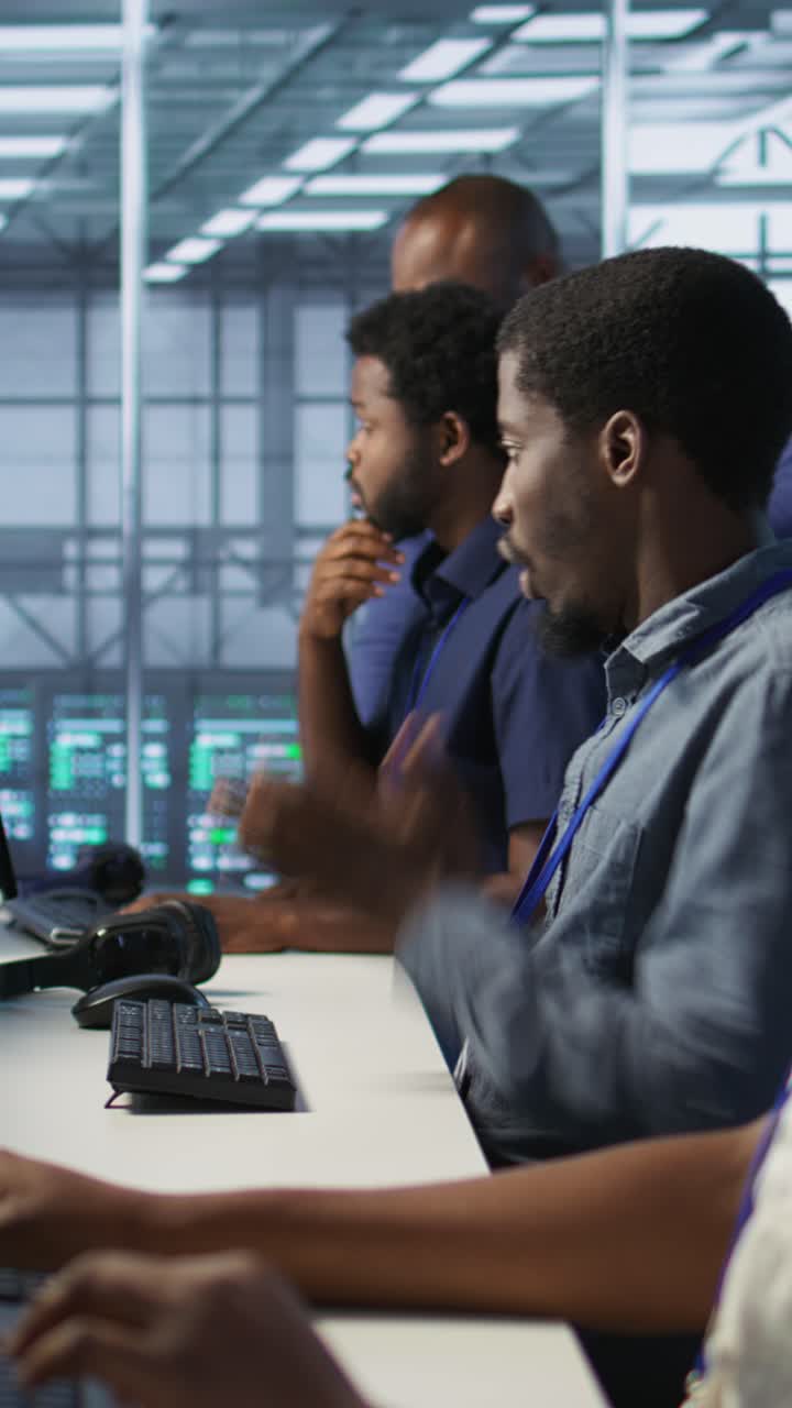 Vertical video Engineers seeing system hacked popup on PC screen in data center