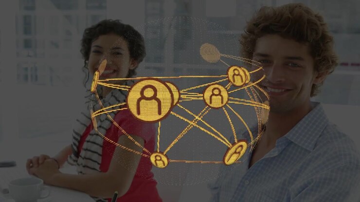 Network globe appearing above desk, rotating nodes while coworkers using devices and showing links
