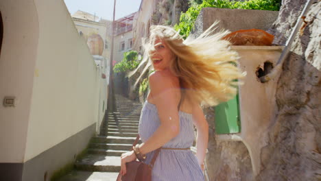 a happy young woman looking back while running up