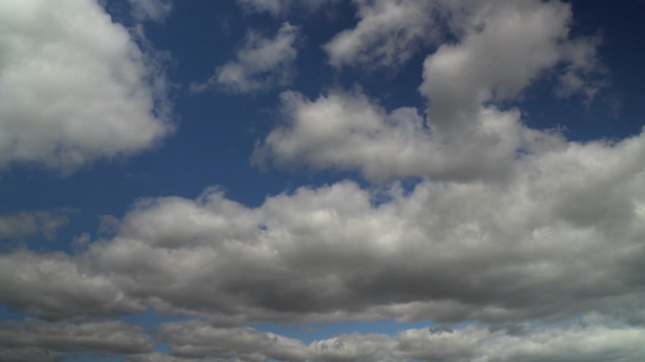 White Clouds Moving Across The Blue Sky. Timelapse 60x.