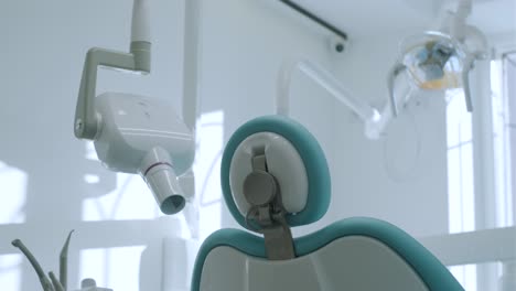 modern dental practice. dental chair and other accessories used by dentists in blue, medic light.