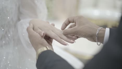 put the ring on the right of the groom in white dress - widdeng ceremony - slow motin