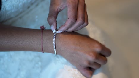 the image features a detailed shot of a lovely bride's hand adorned with a bracelet