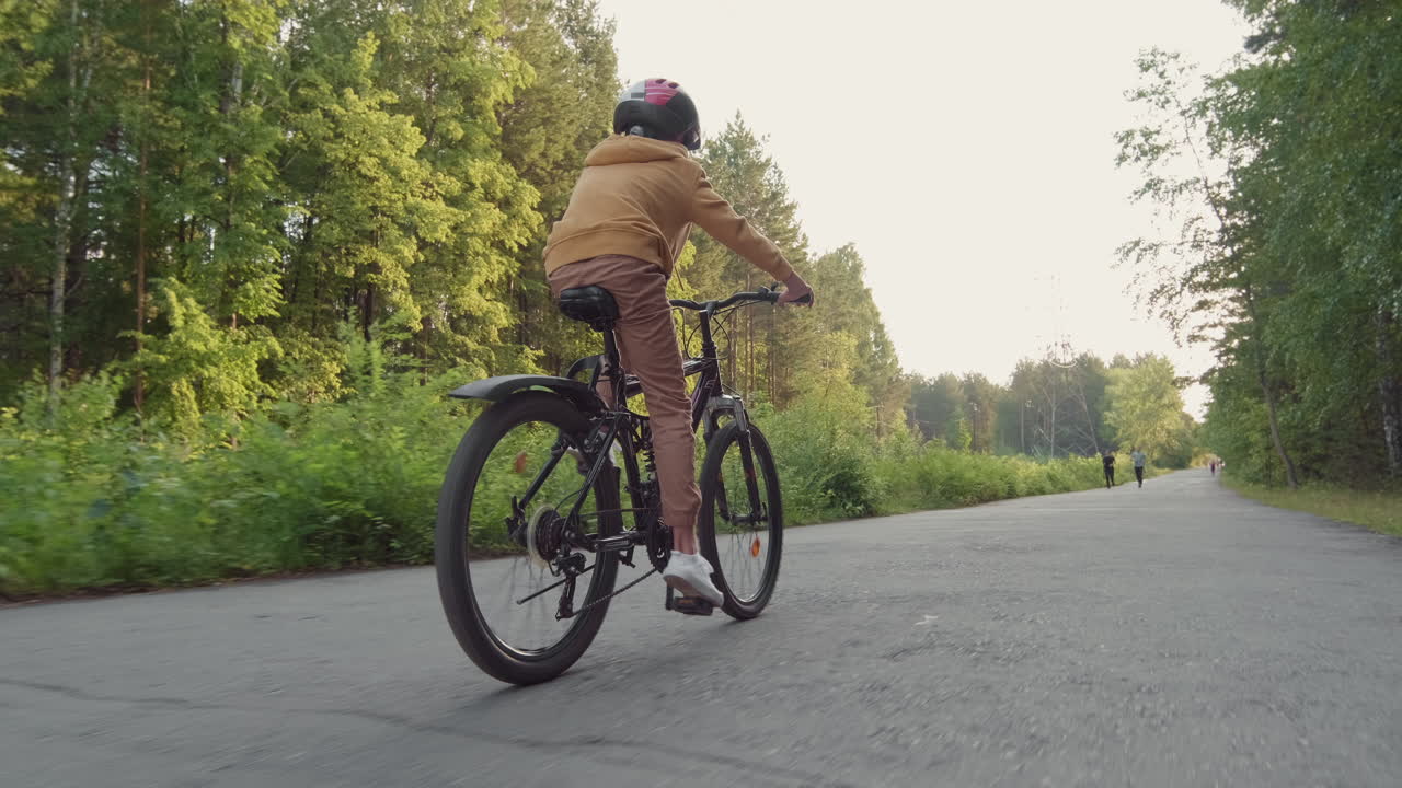 Boy Cycling In Park Alone