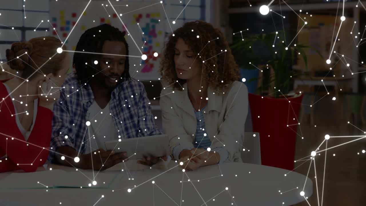 Small team leaning over laptop and papers, overlay appearing and guiding business project decisions