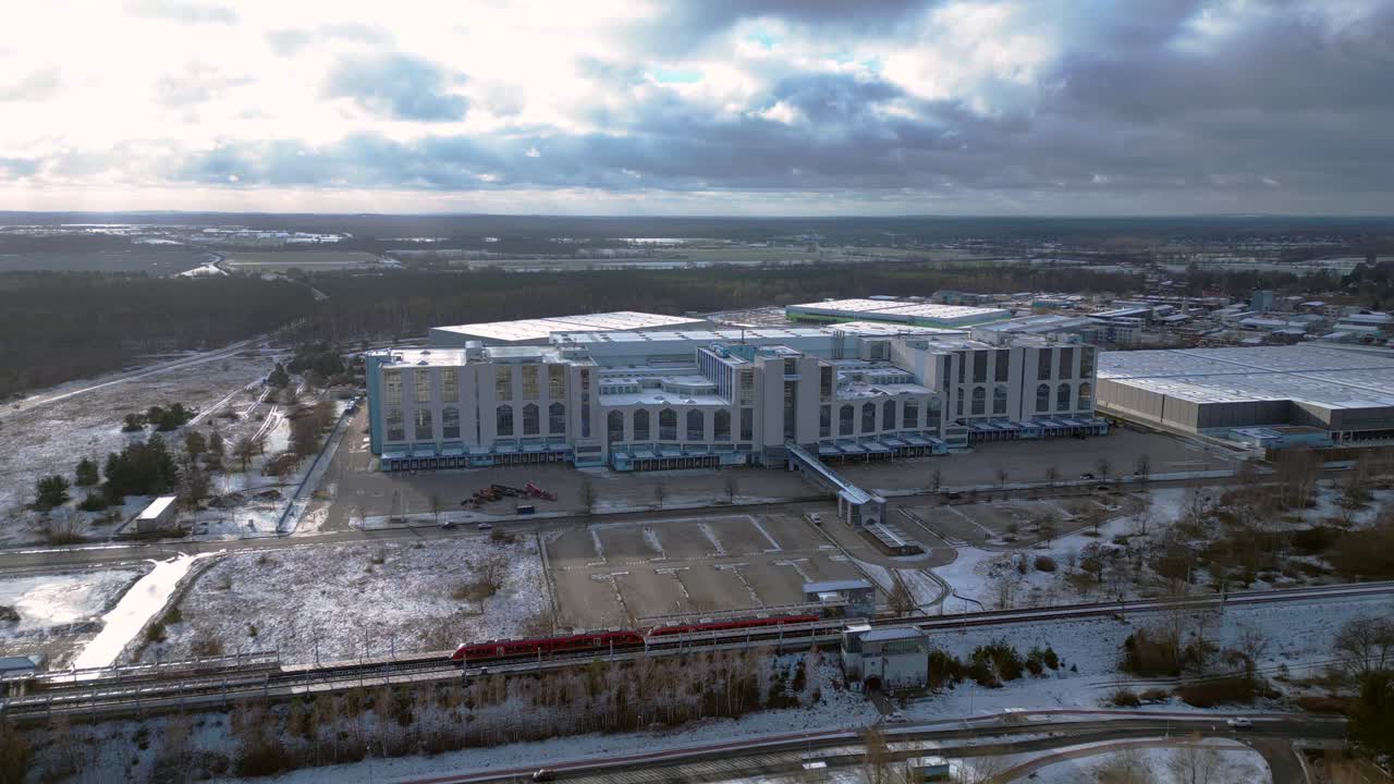 train traveling through a snowy cityscape in segefeld Falkensee. Perfect aerial view flight panorama overview drone