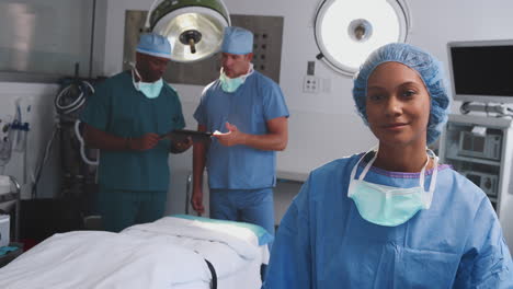 portrait of female surgeon wearing scrubs in hospital operating theater