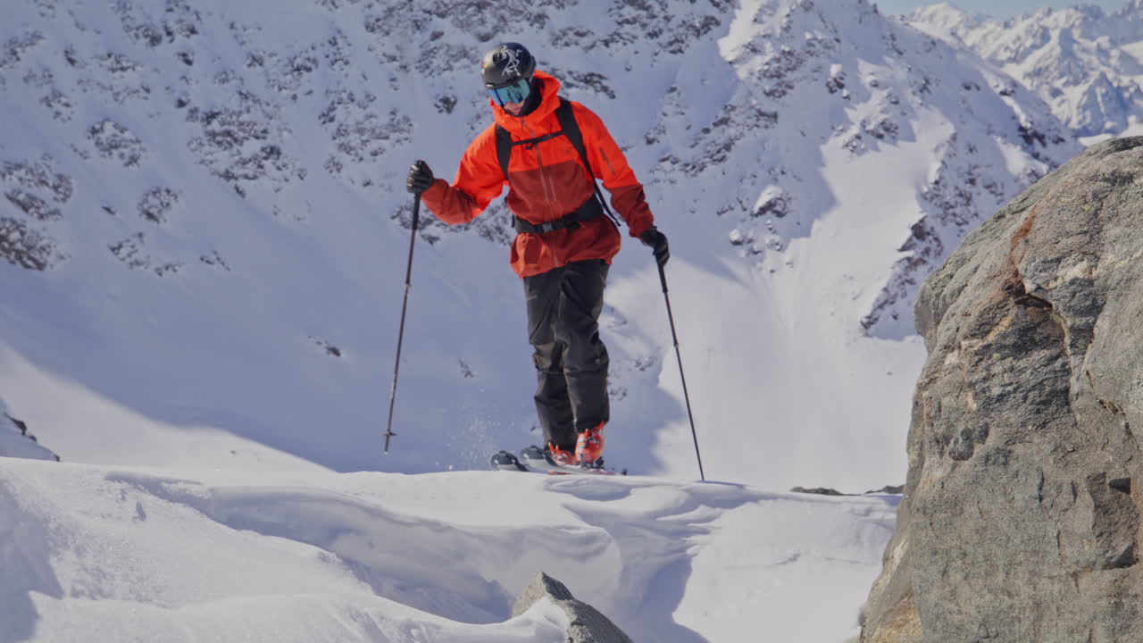 A professional skier hikes up a steep ridge in Verbier, then drops into an epic freeride descent. Pure adventure skiing in deep snow, dramatic terrain, and breathtaking alpine scenery.