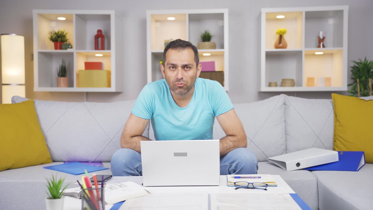 Home office worker man looking at camera curious and confused.