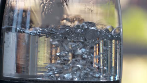 close up of water boiling in a clear glass pot