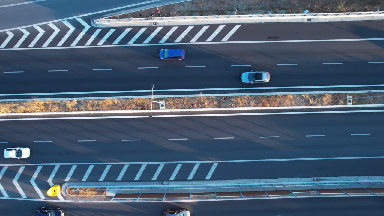 Aerial drone footage showing Tirana suburban highway white stripes of ring road, cars commuting, city infrastructure
