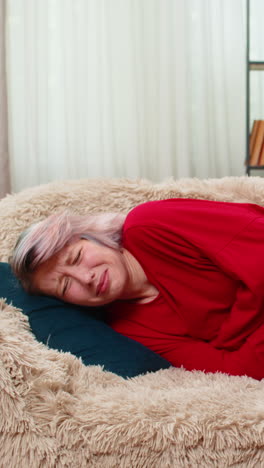 woman experiencing stomach pain holding belly uncomfortable painful facial expression showing ache