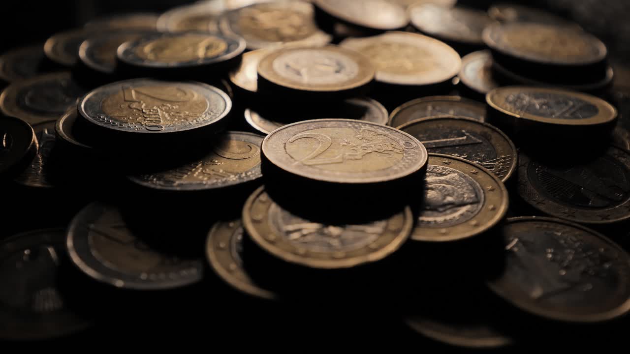 Euro coins stacking up, signifying financial recovery, personal savings growth