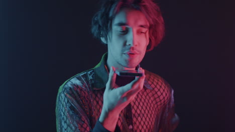 man using mobile phone in neon light