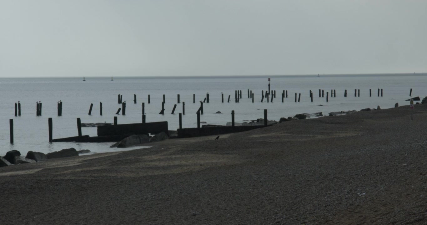 extra wide shot looking south of broken Groynes on Corton beach