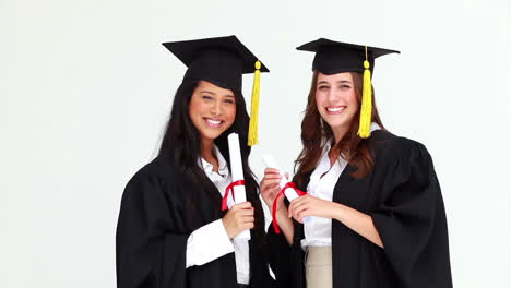 happy graduated classmates talking to each other