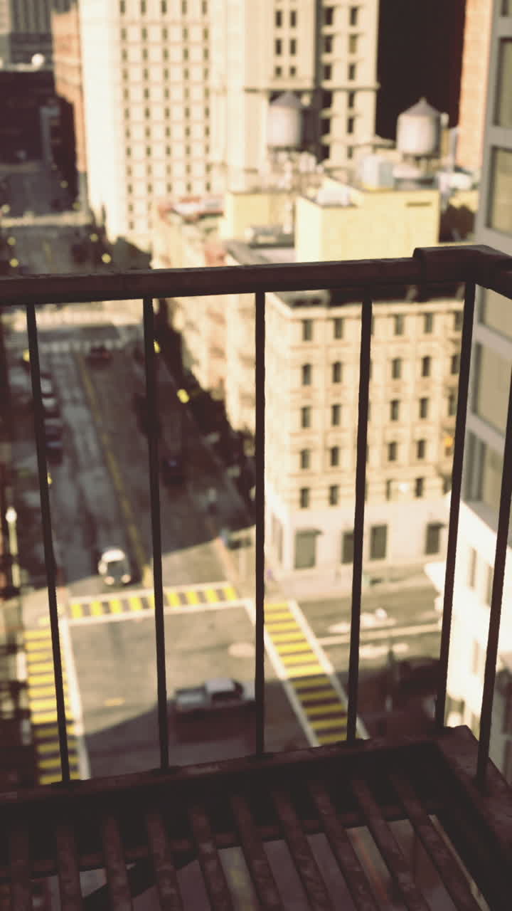 View from a balcony overlooking a busy city street in urban setting