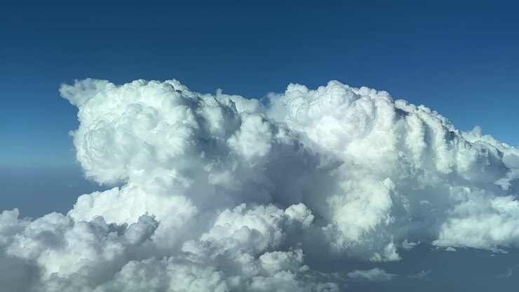 Closeup view of a huge storm cloud, cumuloninmbus type, shot from a jet cockpit flying at 12000m high