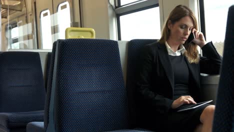 Businesswoman-using-her-tablet-on-the-train