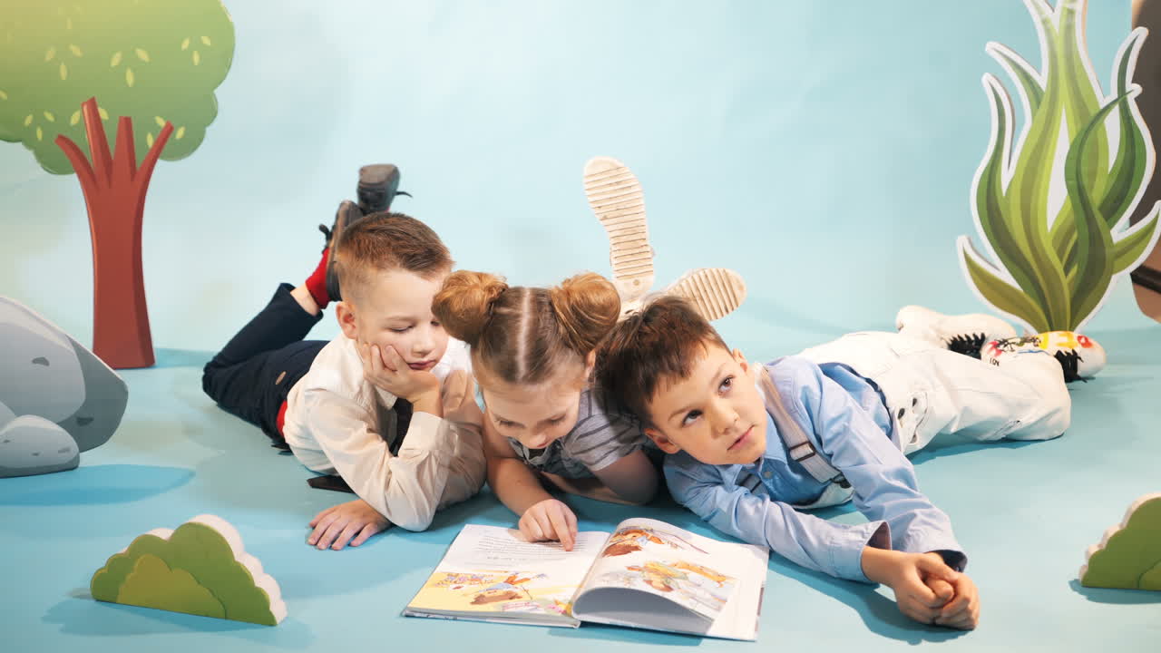 Curious children reading book together. Studio shooting of children