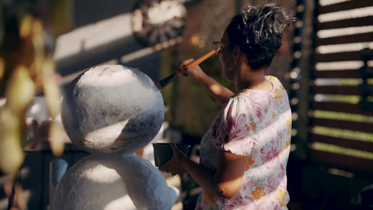 Woman Painting a Sculpture