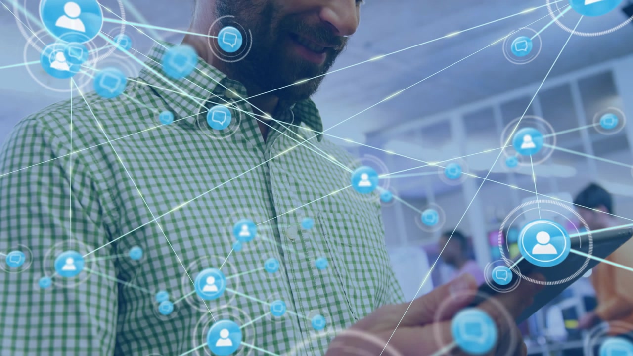 Man tapping tablet, activating blue network icons and lines in tech workspace showing file sharing
