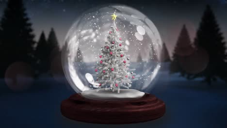 Two-shooting-stars-spinning-around-christmas-tree-in-a-snow-globe-on-winter-landscape