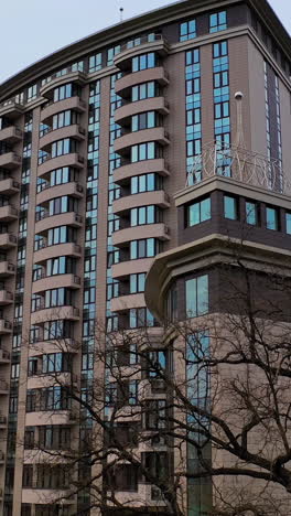 apartment building room in living area. new block of modern apartments with balconies and blue sky in the background. vertical video