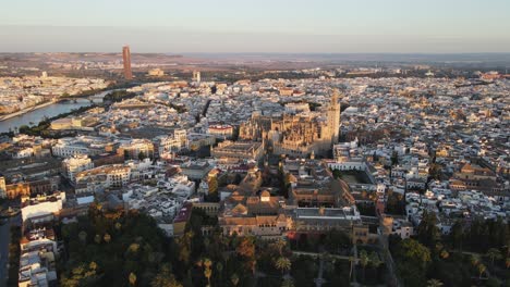 aerial drone shot of seville, the capital city of spain's andalusia region. seville is known for its culture, heritage, and being the birthplace of flamenco. also seen is the bell tower “la giralda”