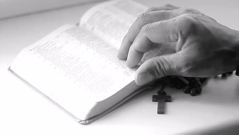 praying-to-God-with-hands-on-bible-on-table-with-people-stock-footage-stock-video