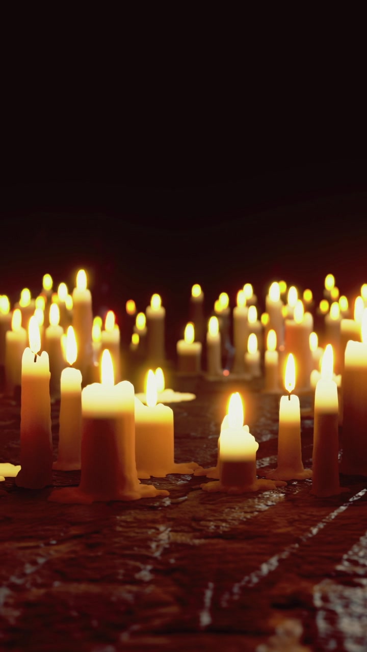 Molte candele accese in un ambiente buio per un'occasione speciale di ritrovo.