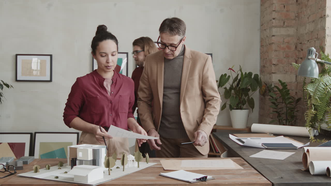Team Of Architects Working On House Design In Office