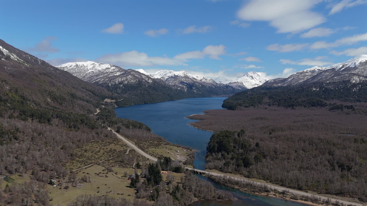 Wide aerial view of stunning Patagonian landscape of Villarino Lake with snow-capped Andean mountains.