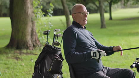 senior golfer with golf clubs
