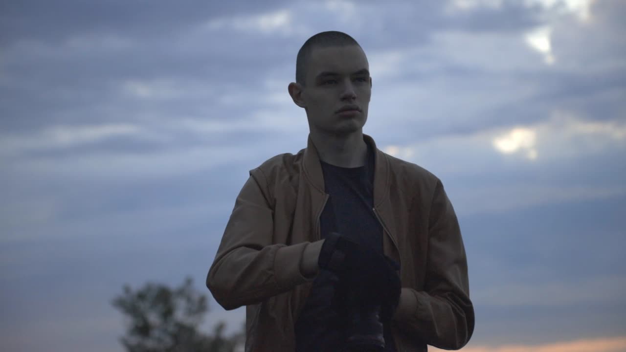 Caucasian Man Taking Pictures And Standing Against The Sunset Sky. - medium shot