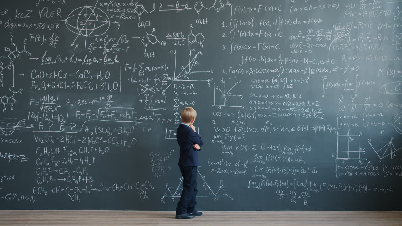 Young Boy Standing in Front of a Chalkboard Filled with Math Equations