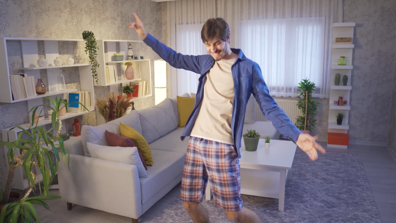The funny guy is trying to dance at home and it's fun for him.