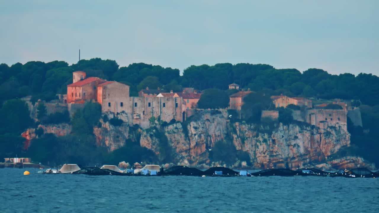 A historic stone fortress and village perched on a high cliff above the Mediterranean Sea