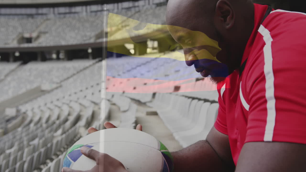 Holding rugby ball, player in empty stadium with flag animation overlay
