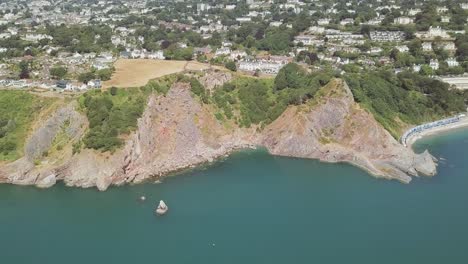 Aerial-reveal-of-small-town,-overseeing-English-Channel